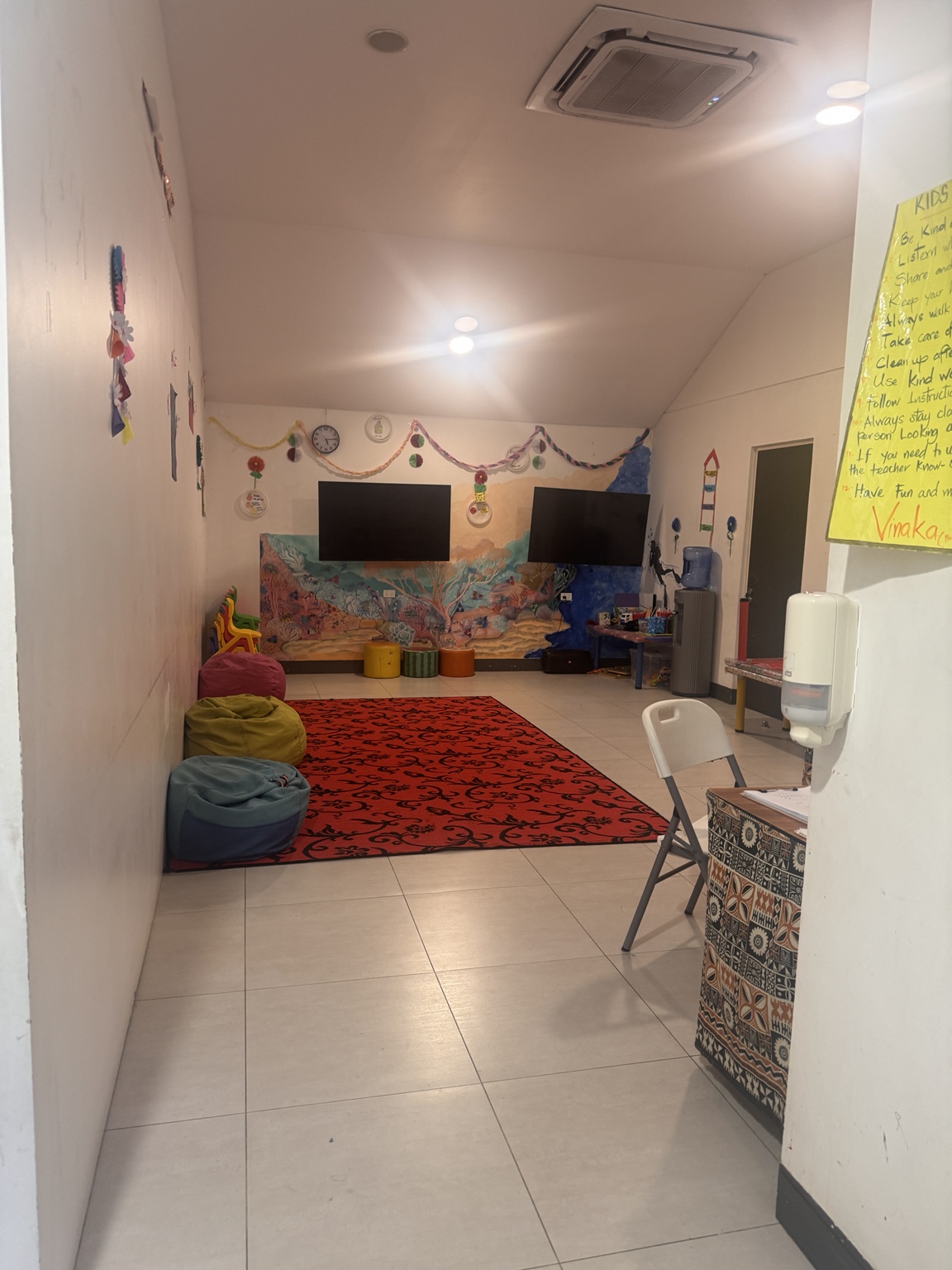 Inside the kids’ club: two televisions and a small indoor activity space.