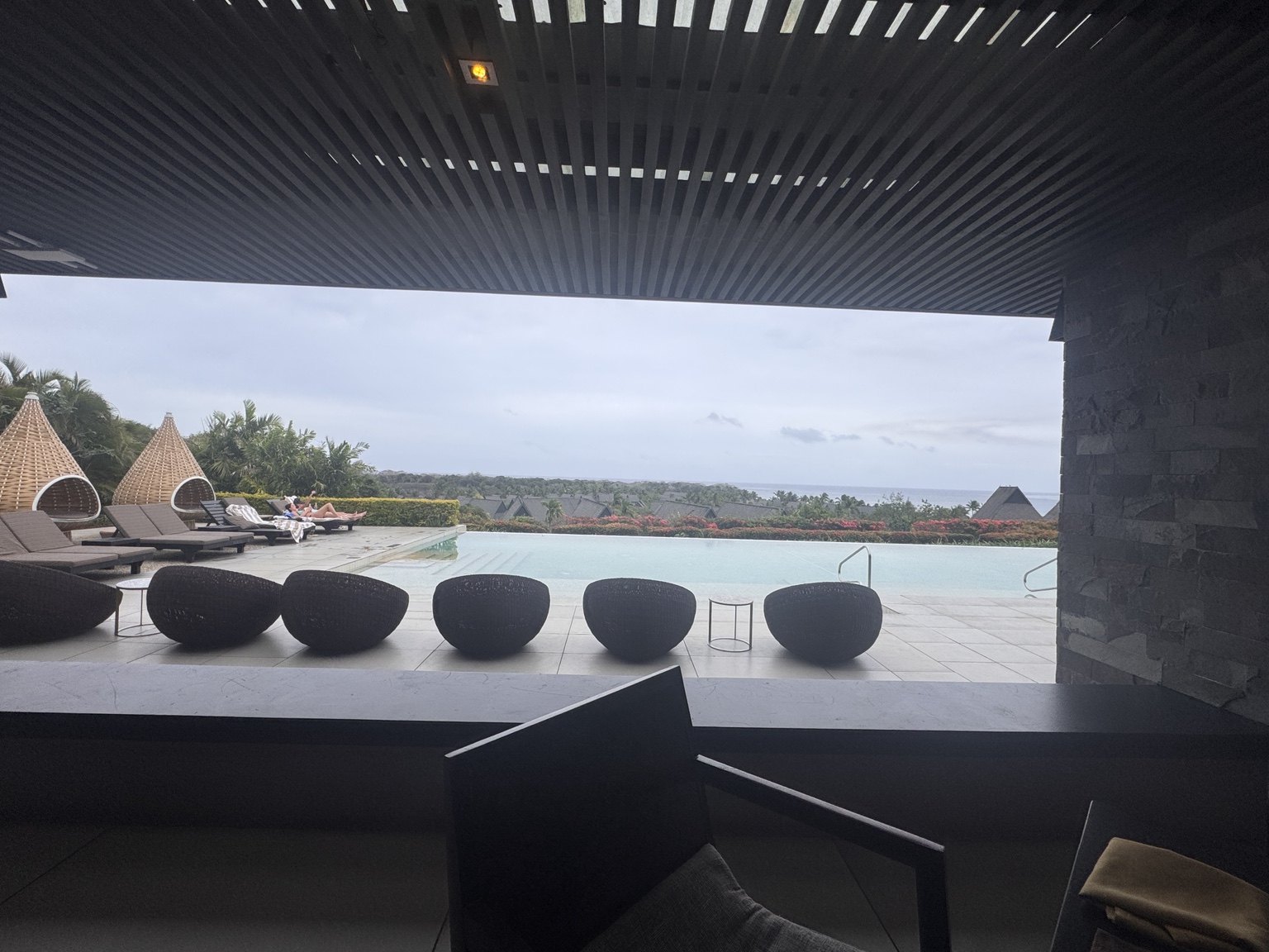 View from the shaded Club lounge across its pool towards the ocean
