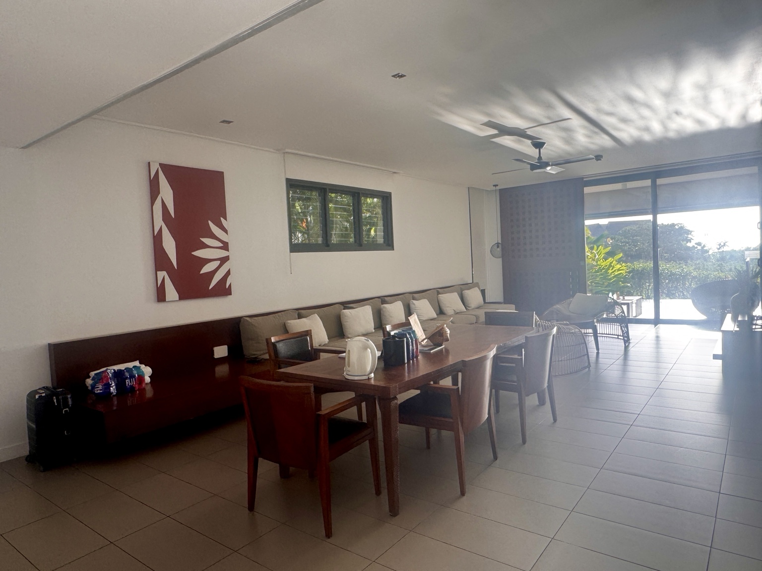 The shared dining and living space, with built-in seating extending towards the terrace.