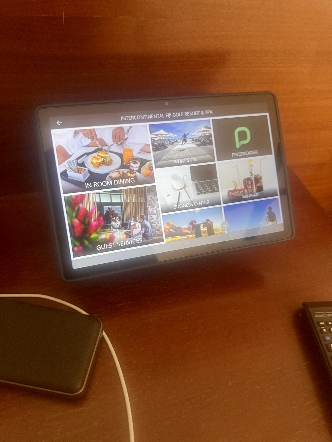 The in-room tablet displays dining and guest-service information.